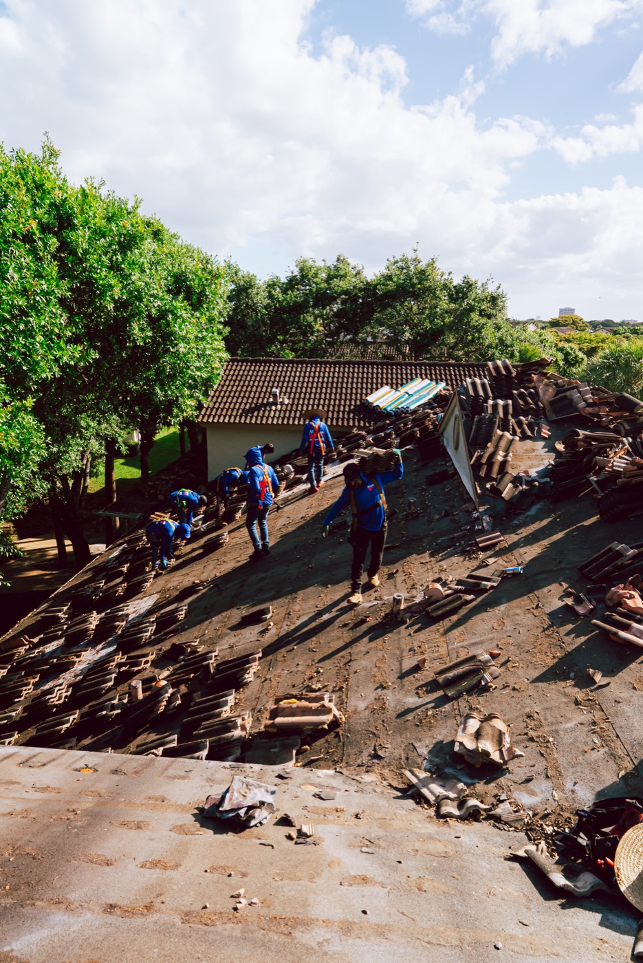 Molsbee crew members working a tile tear-off, photo 1