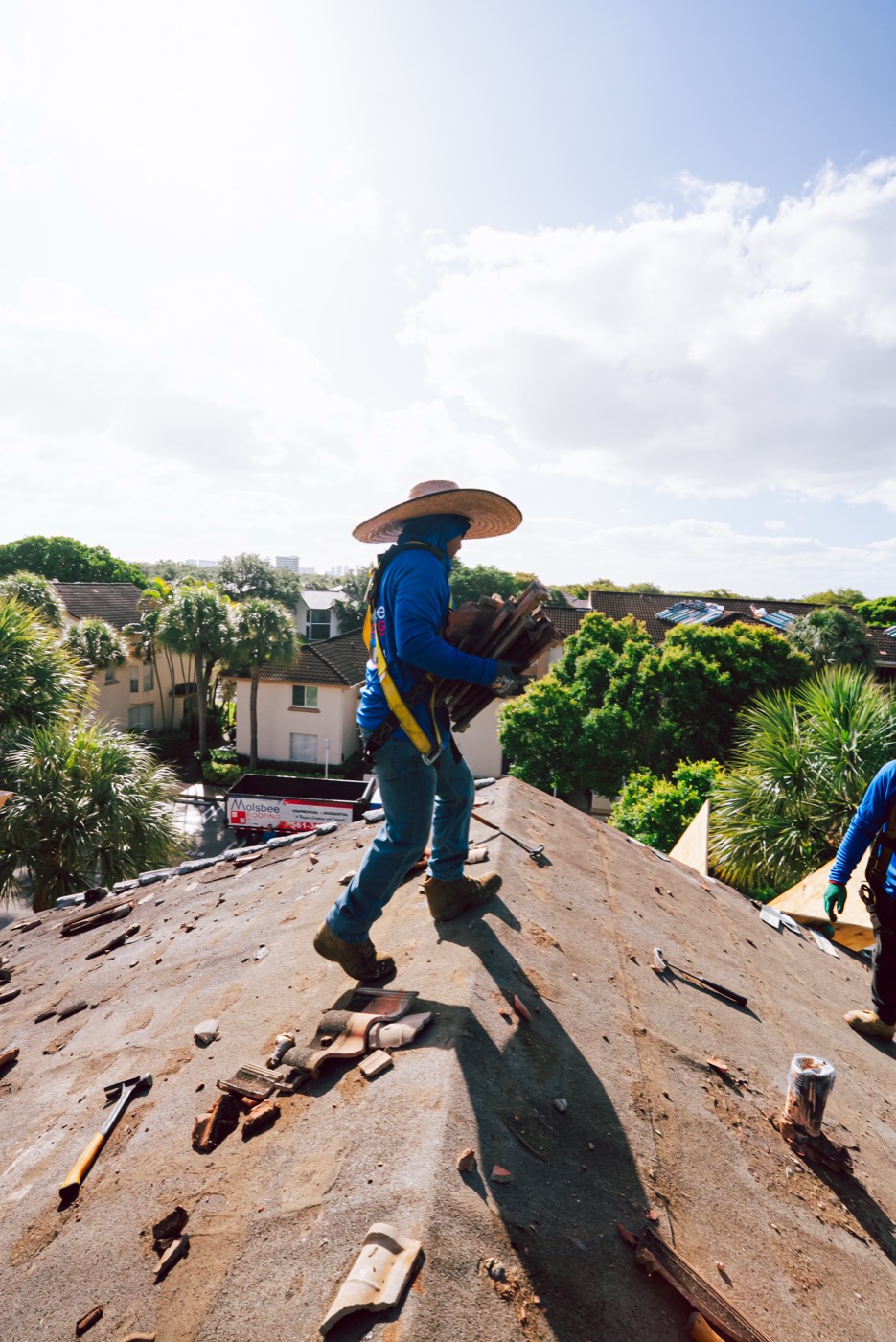 Molsbee crew members working a tile tear-off, photo 3