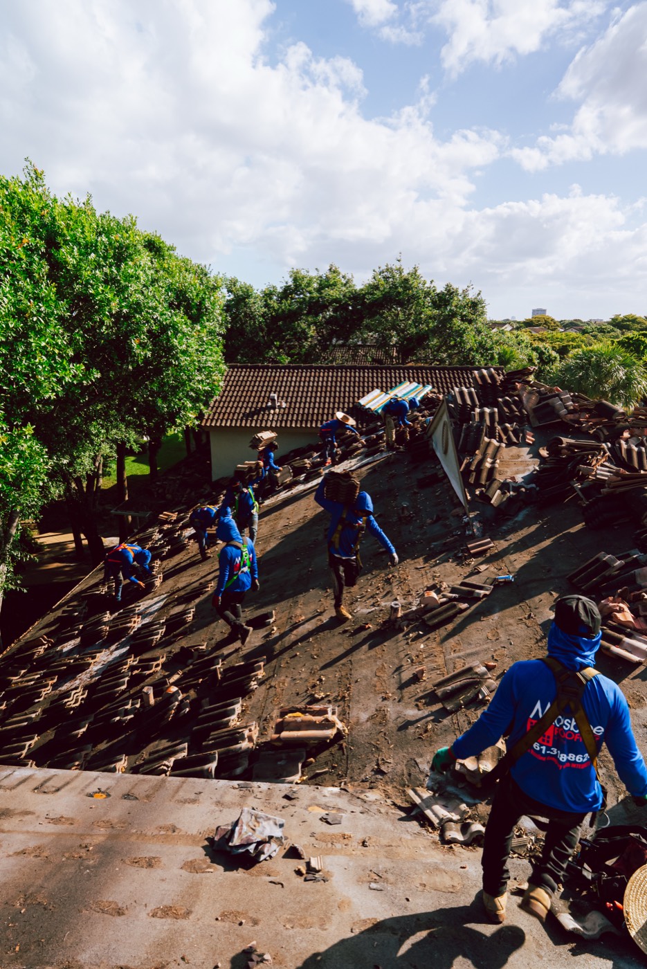 Molsbee crew members working a tile tear-off, photo 4