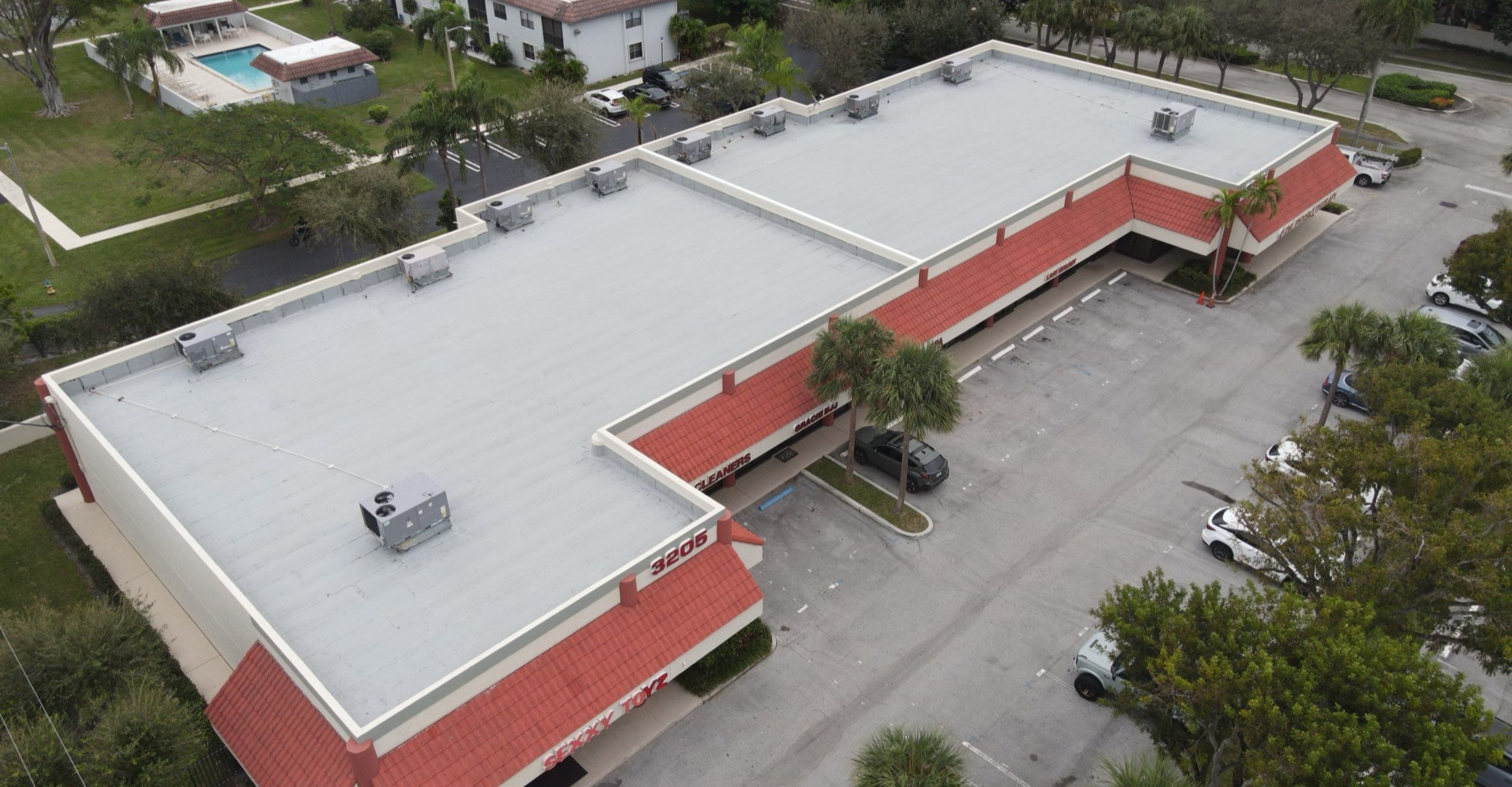 New flat roof across a retail shopping plaza, seen from the air