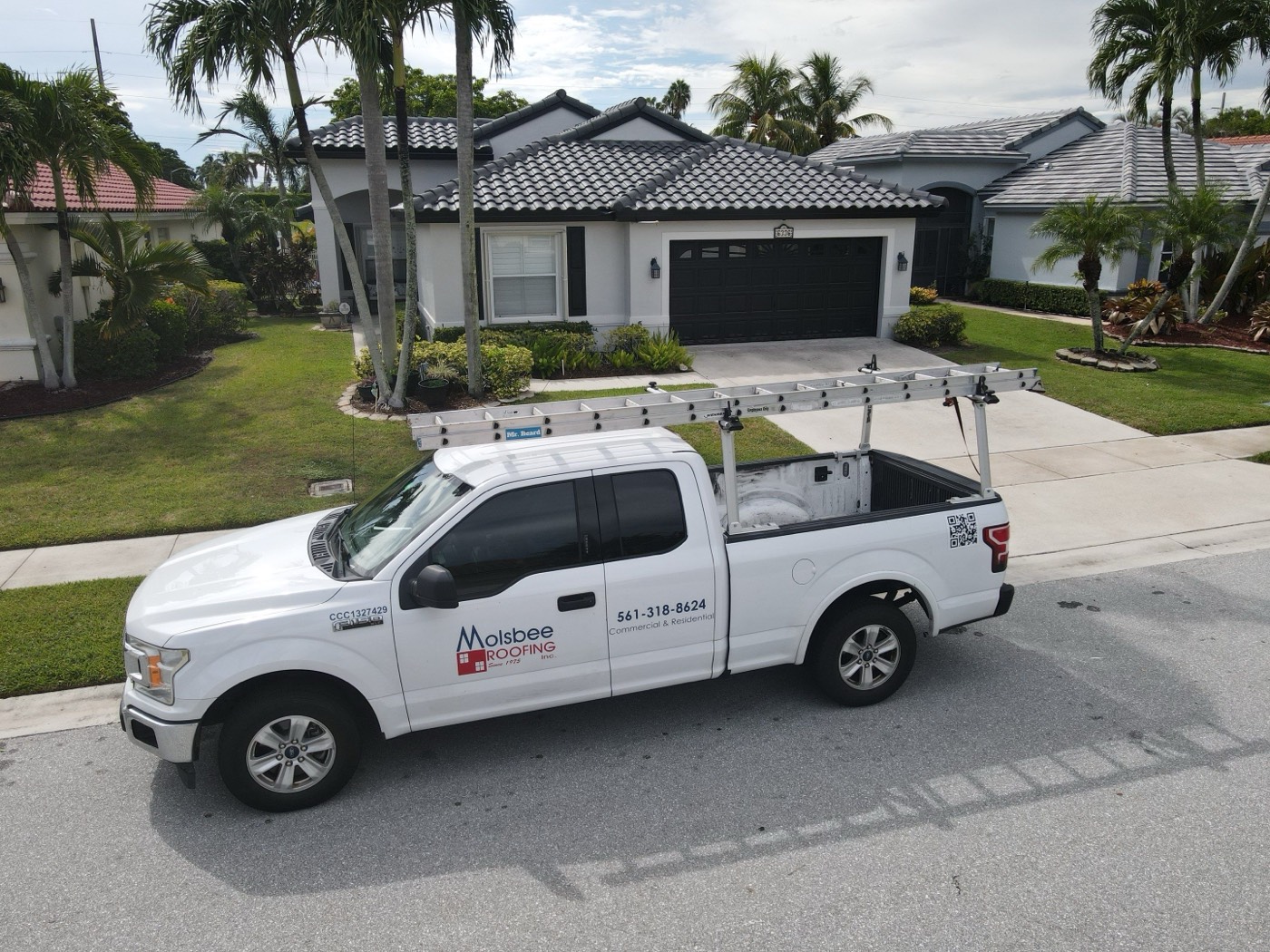 Molsbee Roofing truck parked outside a Palm Beach County home with a new tile roof