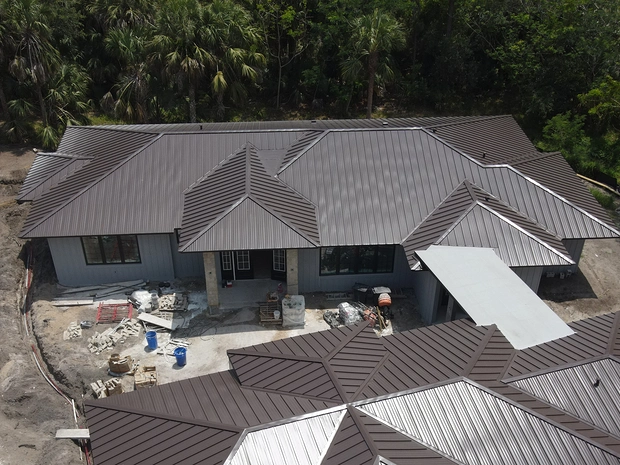 Aerial view of a new home with a bronze metal roof