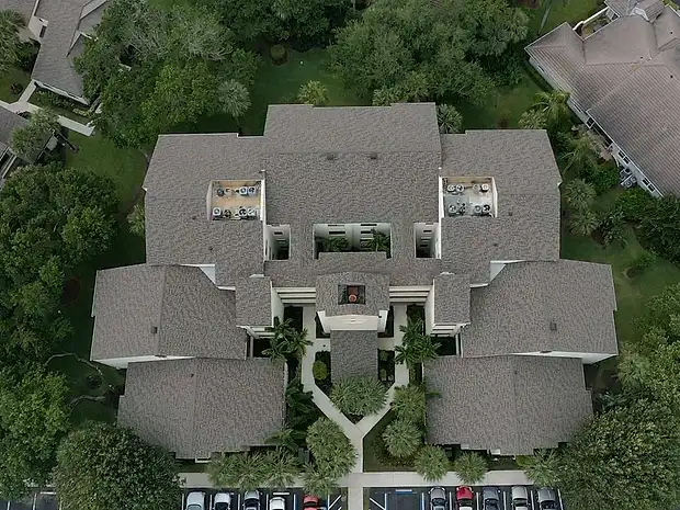 Aerial view of a condominium community with new shingle roofs