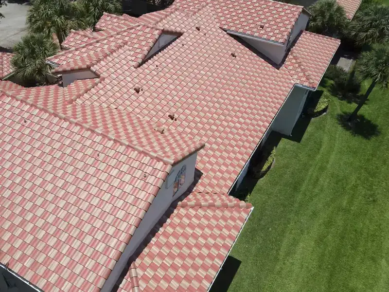 Close aerial of a finished blended clay tile roof, ridge caps and courses visible