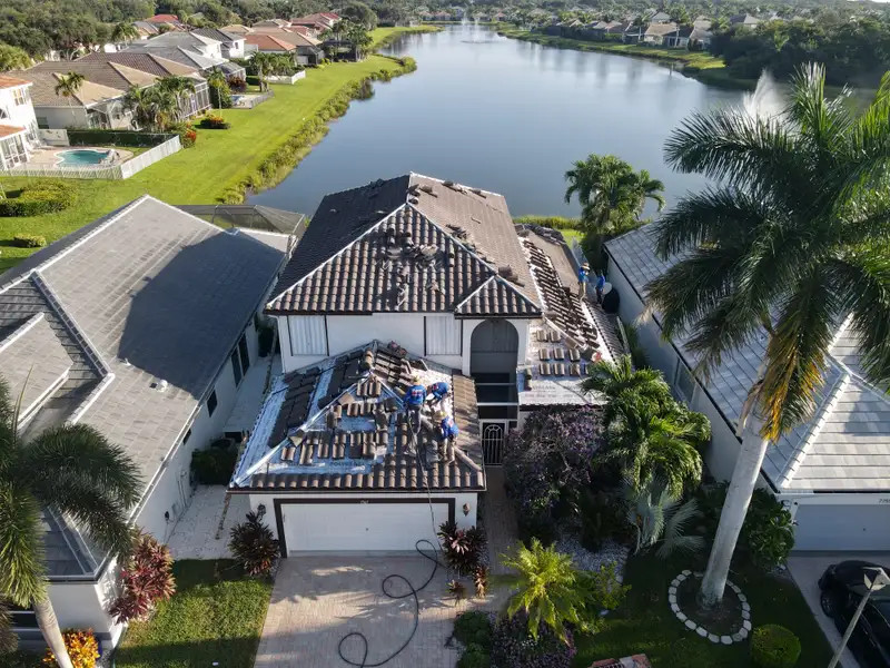 Molsbee crew laying new tile on a lakefront home, seen by drone