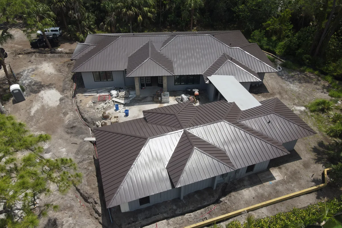 Bronze standing-seam metal roof on a new build, seen from above