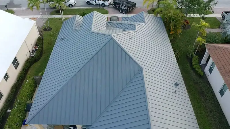 Aerial view of a home with a new grey standing-seam metal roof